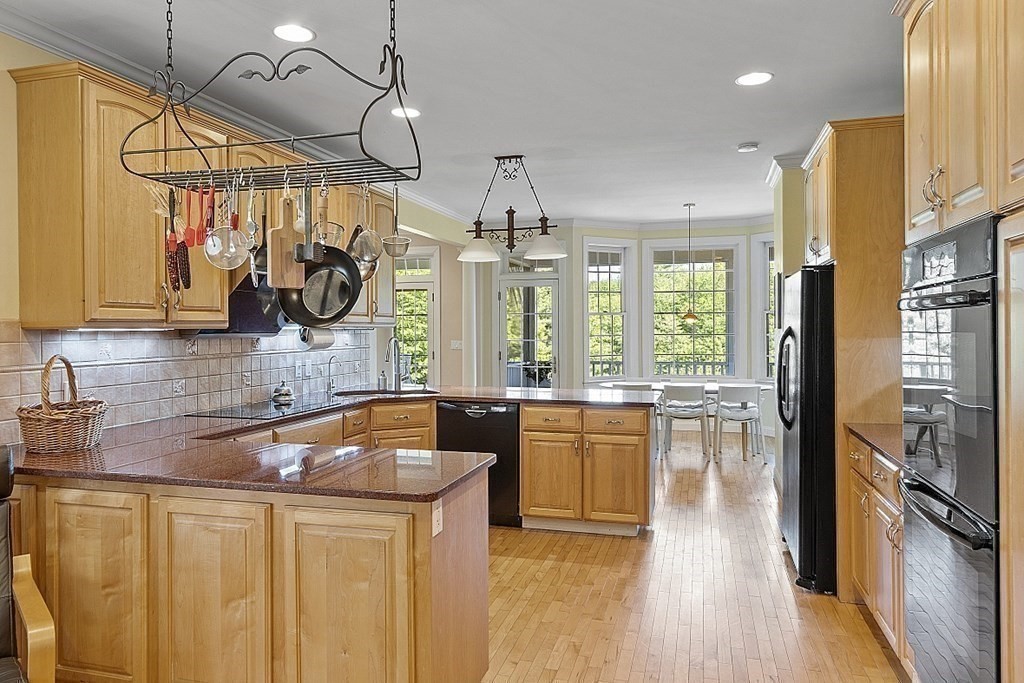 100 West Berlin Road Bolton, MA 01740 - Photo 16 of 42 a kitchen with stainless steel appliances granite countertop a sink a stove and a wooden floors