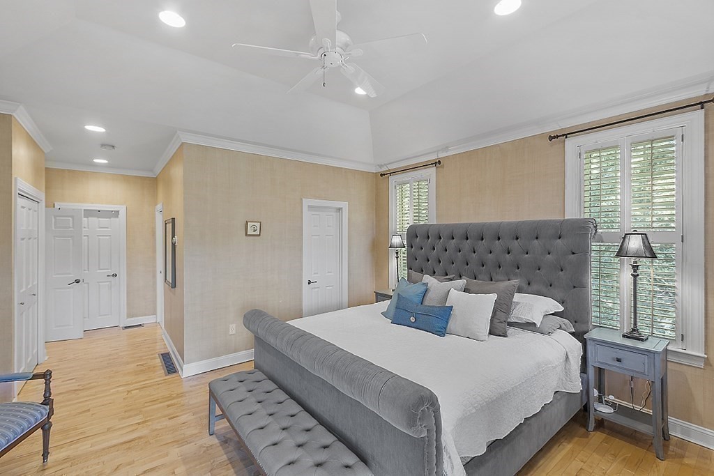 100 West Berlin Road Bolton, MA 01740 - Photo 22 of 42 a bedroom with a large bed and a chandelier
