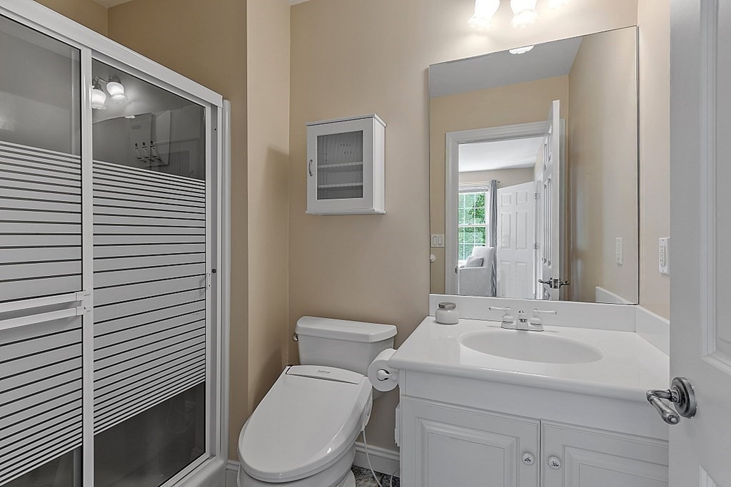 100 West Berlin Road Bolton, MA 01740 - Photo 27 of 42 a bathroom with a toilet sink vanity and mirror