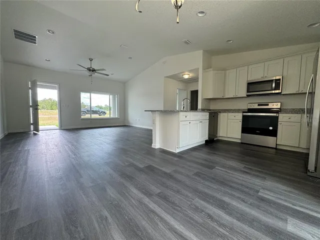 a kitchen with stainless steel appliances a refrigerator sink and stove top oven
