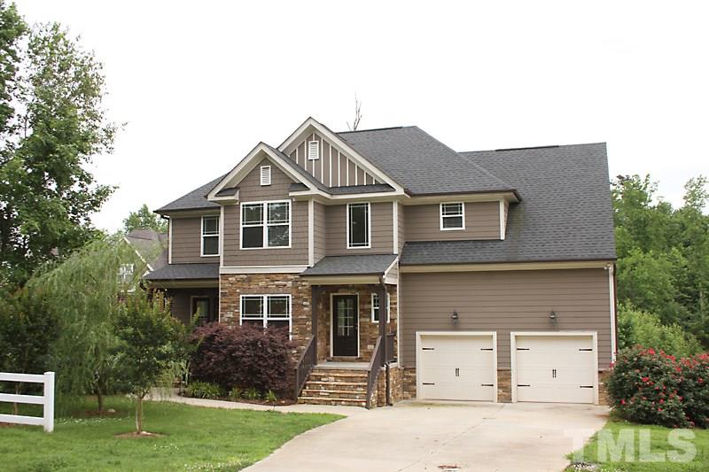 7332 Denlee Road Raleigh, NC 27603 - Photo 1 of 24 a front view of a house with a yard and garage