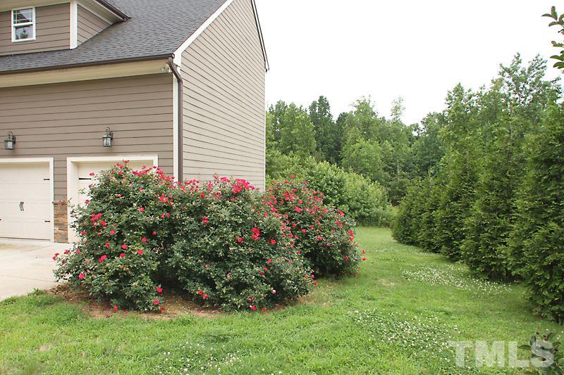 7332 Denlee Road Raleigh, NC 27603 - Photo 2 of 24 a view of a house with a yard and garden