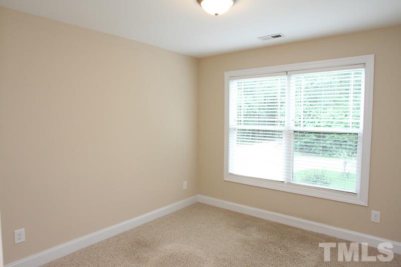 7332 Denlee Road Raleigh, NC 27603 - Photo 13 of 24 a view of an empty room with a window