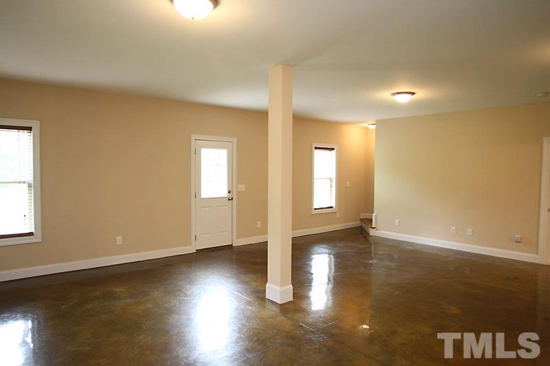 7332 Denlee Road Raleigh, NC 27603 - Photo 18 of 24 an empty room with wooden floor and windows