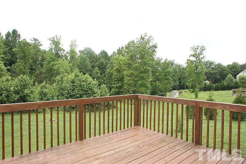 7332 Denlee Road Raleigh, NC 27603 - Photo 20 of 24 a balcony with wooden floor and fence