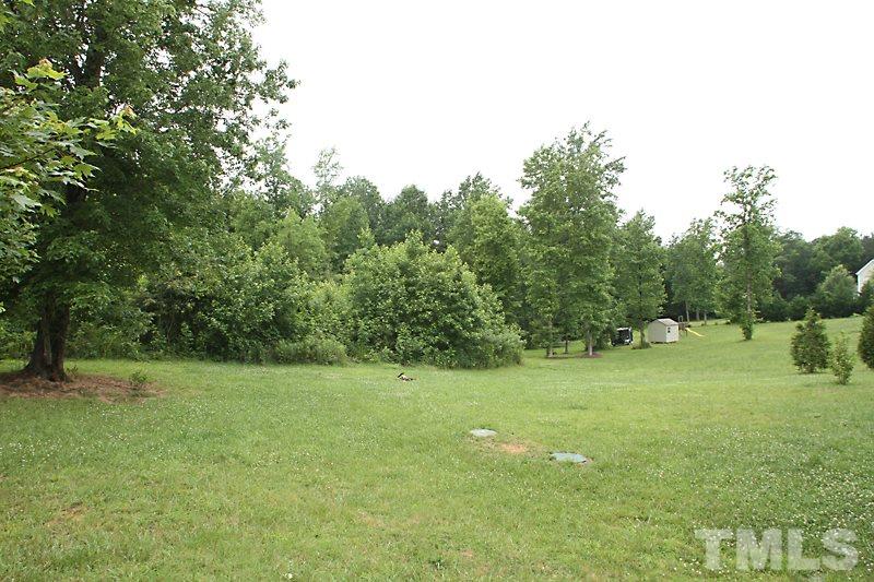 7332 Denlee Road Raleigh, NC 27603 - Photo 22 of 24 a view of a field with trees in the background
