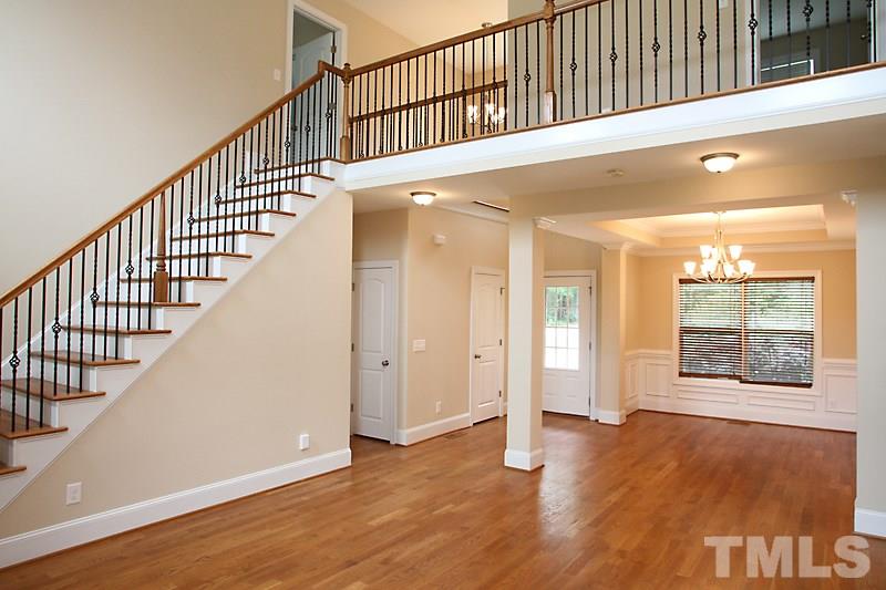 7332 Denlee Road Raleigh, NC 27603 - Photo 6 of 24 a view of an entryway with wooden floor