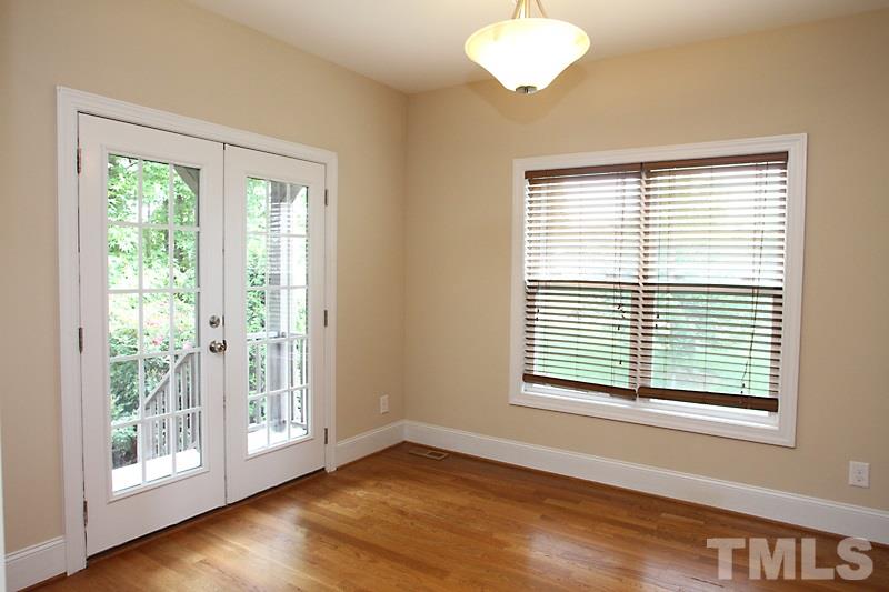 7332 Denlee Road Raleigh, NC 27603 - Photo 8 of 24 a view of an empty room with wooden floor and a window