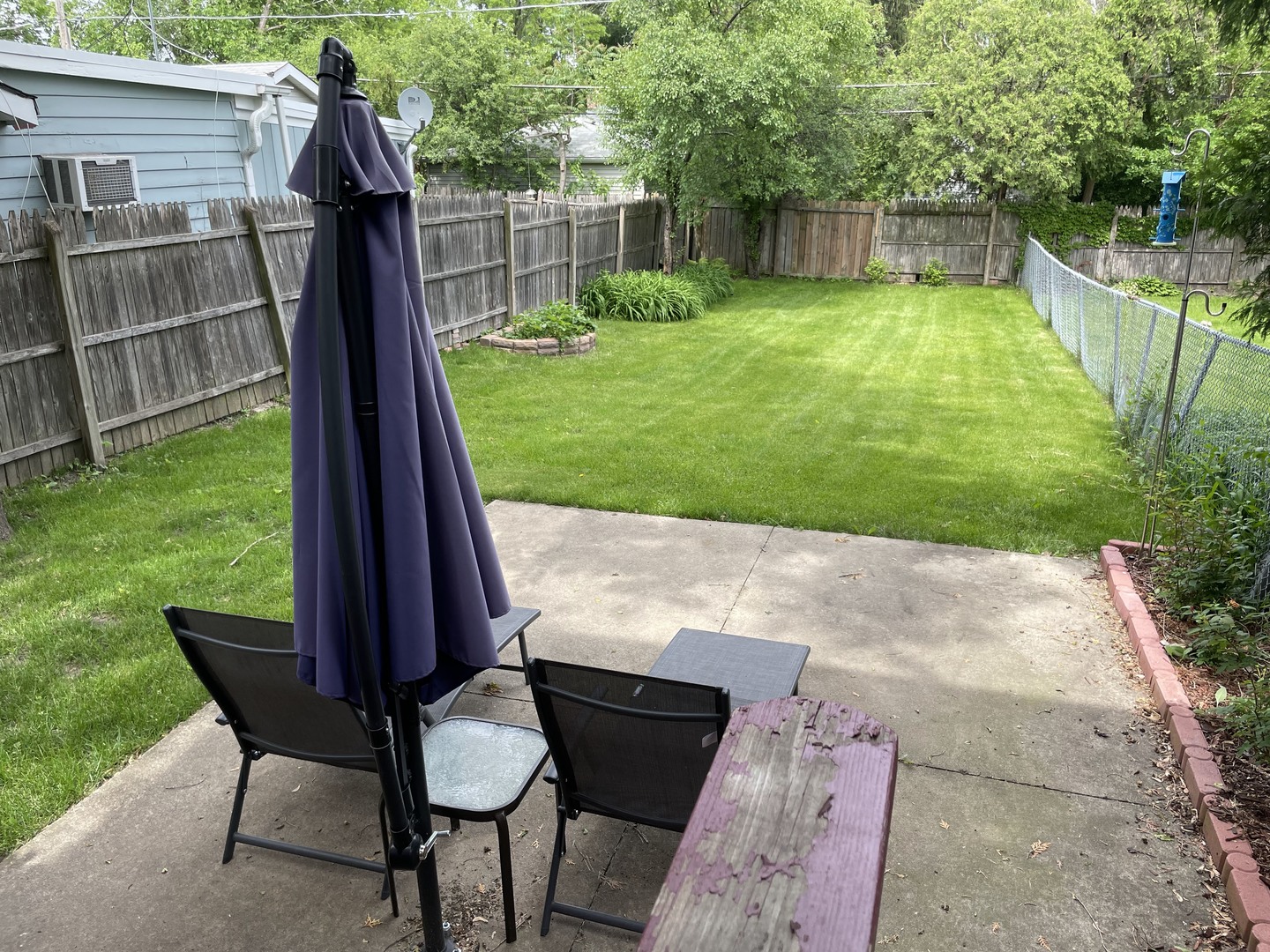 623 Waukegan Road Deerfield, IL 60015 - Photo 13 of 16 a view of backyard with table and chairs and wooden fence
