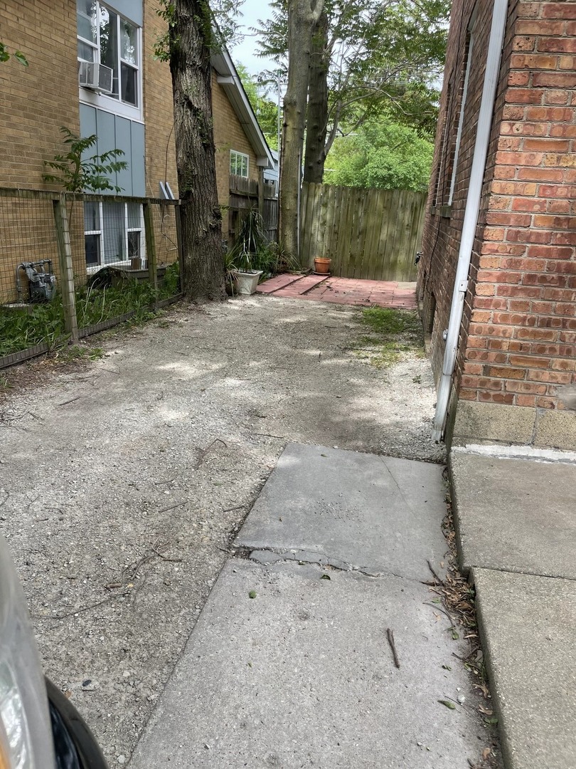 623 Waukegan Road Deerfield, IL 60015 - Photo 14 of 16 a view of a yard with a wooden fence
