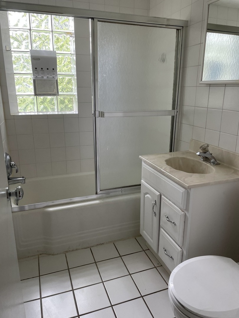 623 Waukegan Road Deerfield, IL 60015 - Photo 15 of 16 a bathroom with a sink a toilet and shower