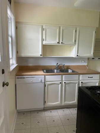 a utility room with cabinets washer and dryer