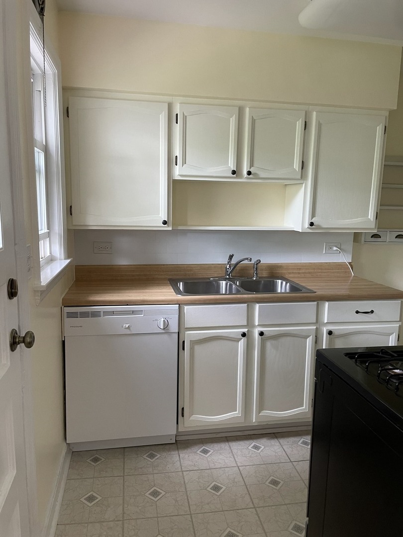 623 Waukegan Road Deerfield, IL 60015 - Photo 3 of 16 a utility room with cabinets washer and dryer
