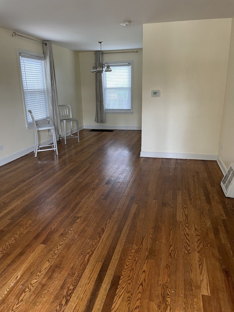 623 Waukegan Road Deerfield, IL 60015 - Photo 5 of 16 an empty room with wooden floor and windows