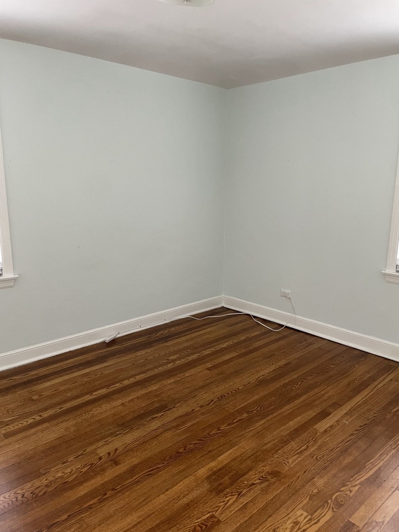 623 Waukegan Road Deerfield, IL 60015 - Photo 8 of 16 a view of an empty room with wooden floor