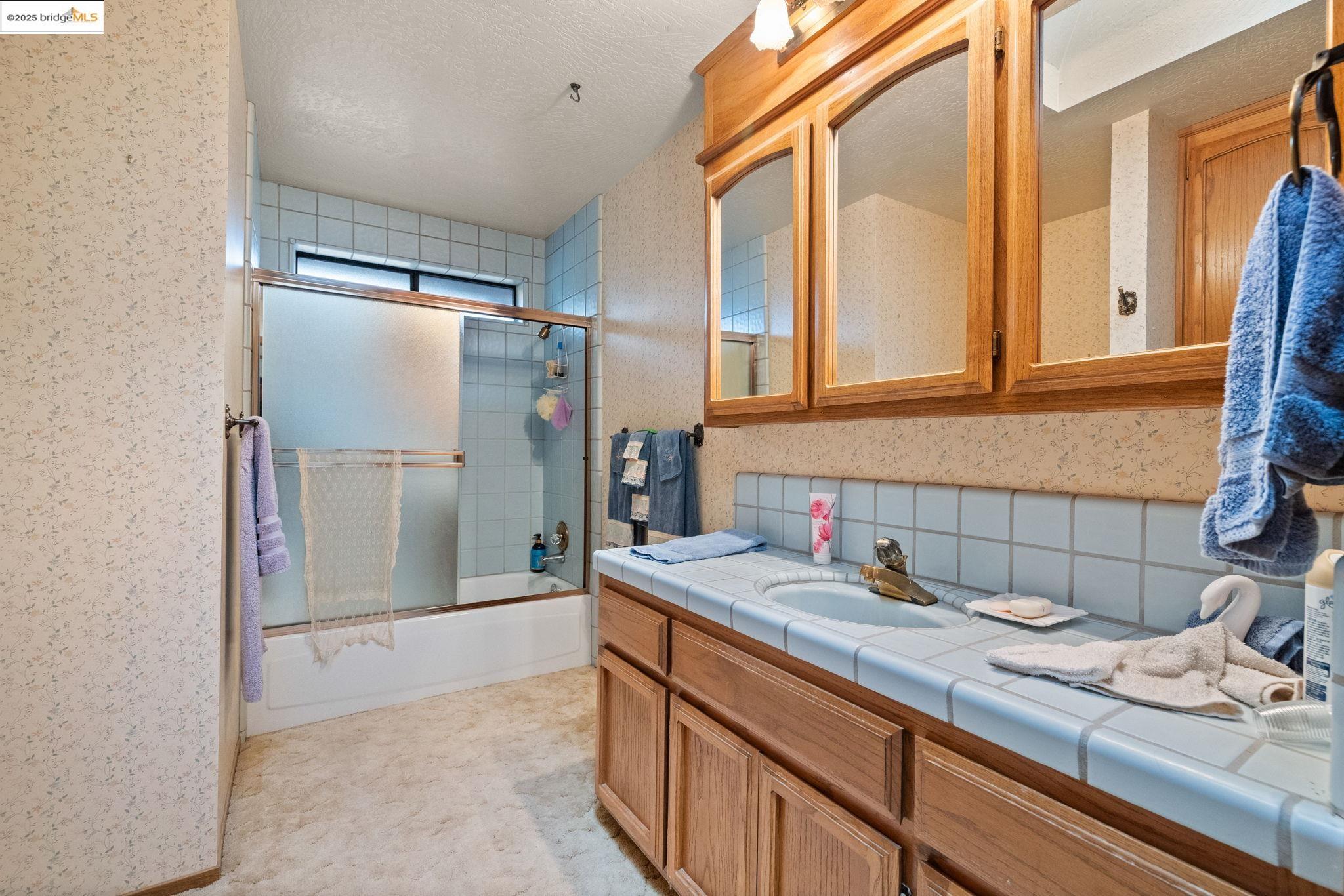 12087 Breckenridge Road Groveland, CA 95321 - Photo 12 of 31 a bathroom with a sink and a mirror