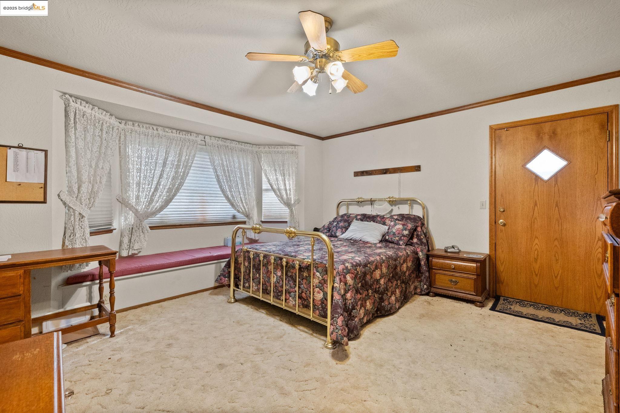 12087 Breckenridge Road Groveland, CA 95321 - Photo 13 of 31 a bedroom with a bed and a chandelier