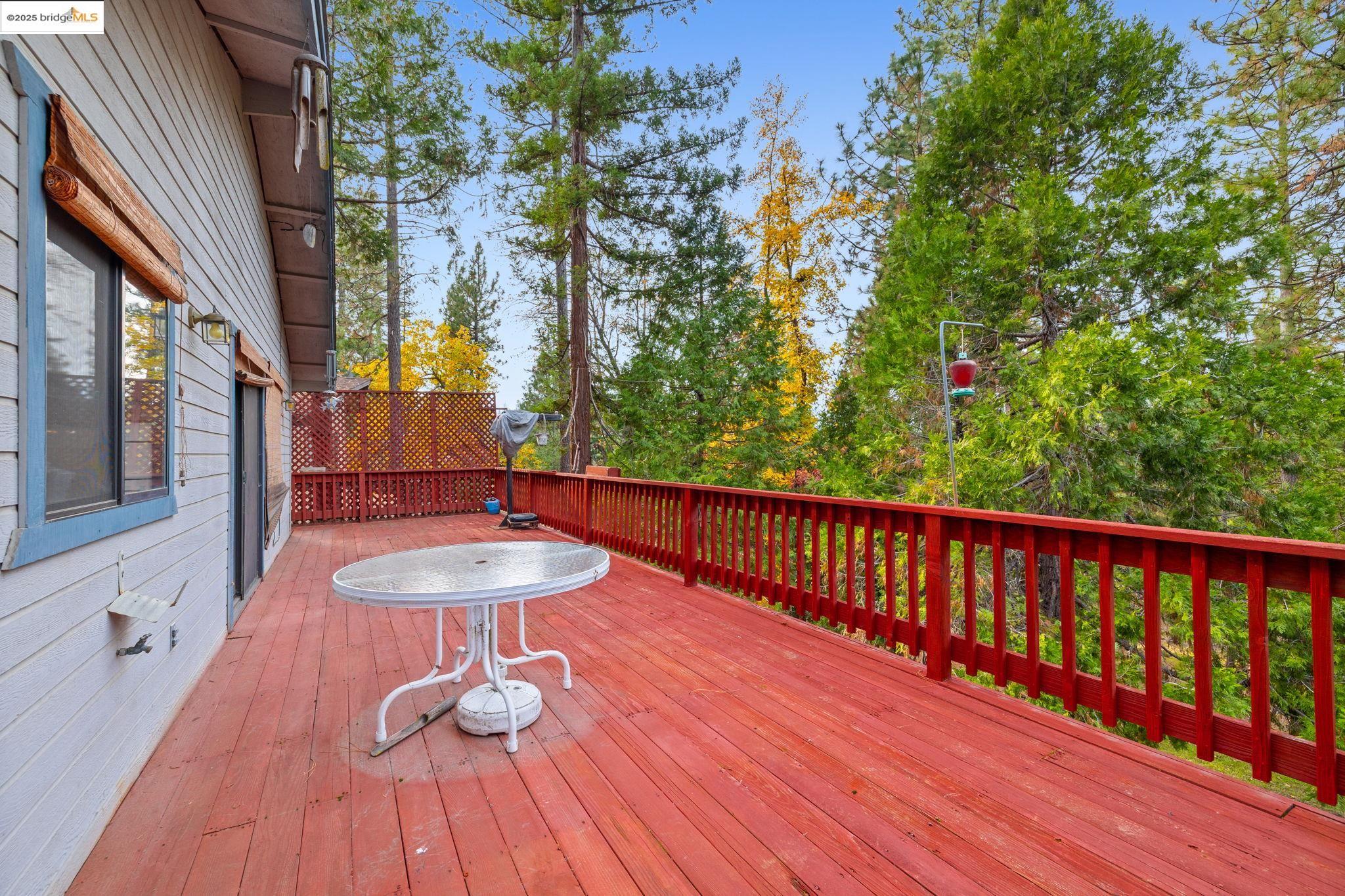 12087 Breckenridge Road Groveland, CA 95321 - Photo 22 of 31 a view of balcony with wooden floor and outdoor seating