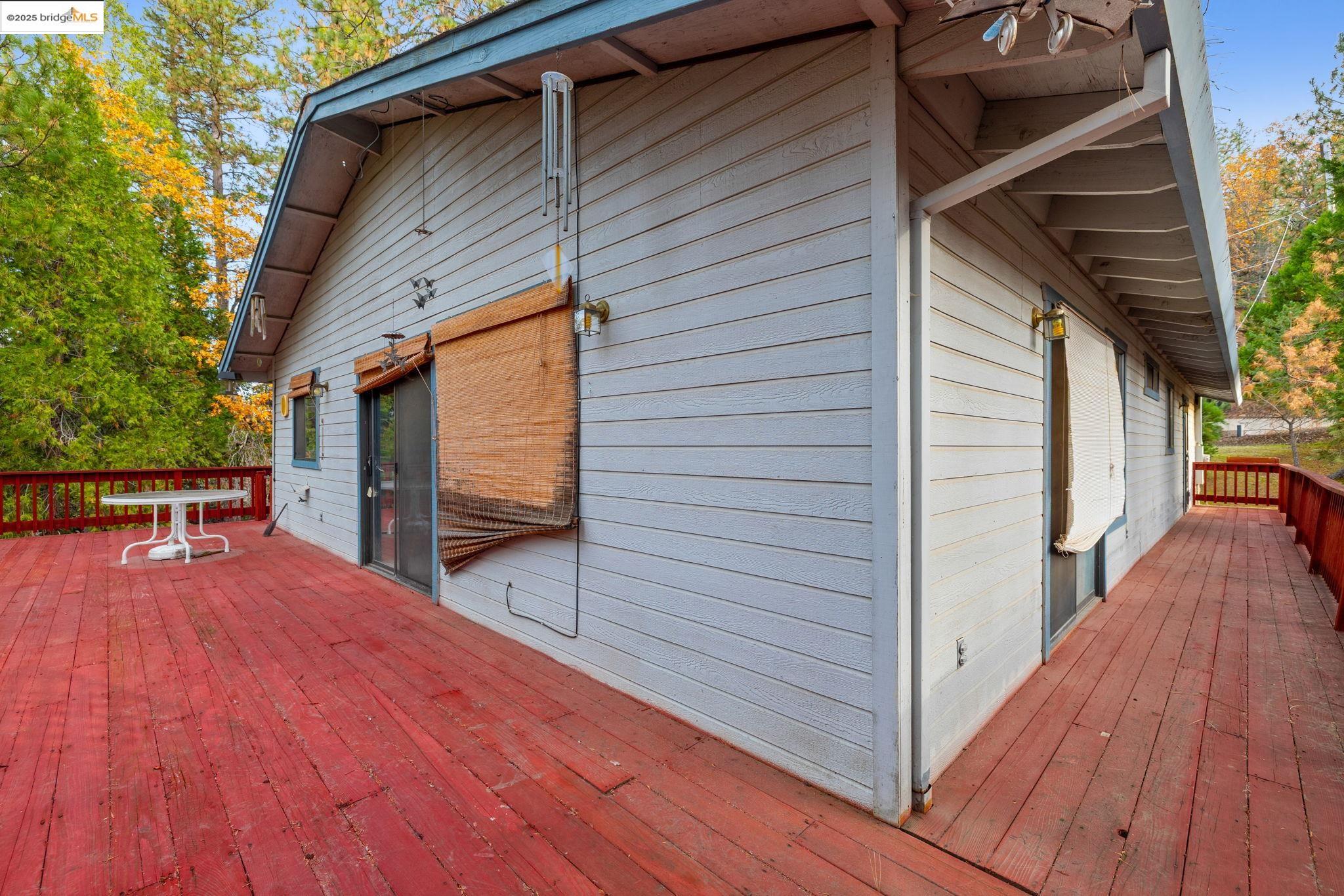 12087 Breckenridge Road Groveland, CA 95321 - Photo 23 of 31 a view of a balcony with wooden floor and floor to ceiling window