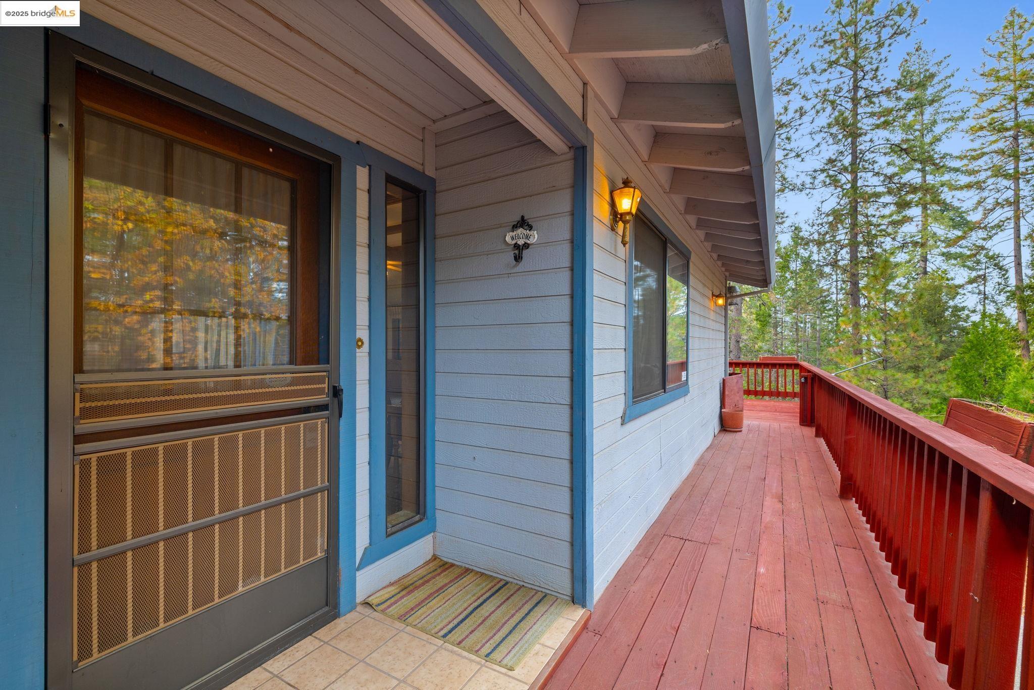 12087 Breckenridge Road Groveland, CA 95321 - Photo 5 of 31 a view of a balcony with wooden floor and stairs