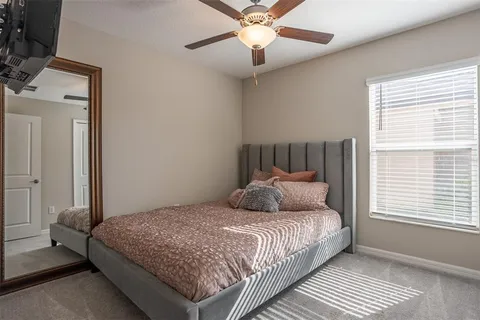 a bathroom with a granite countertop sink a toilet a shower and a mirror