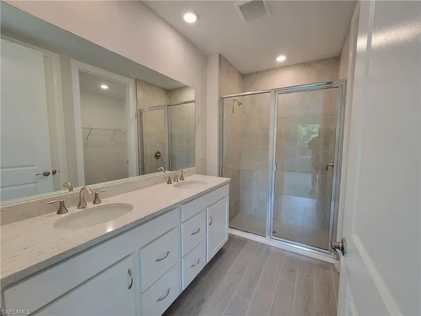 a bathroom with a double vanity sink and mirror