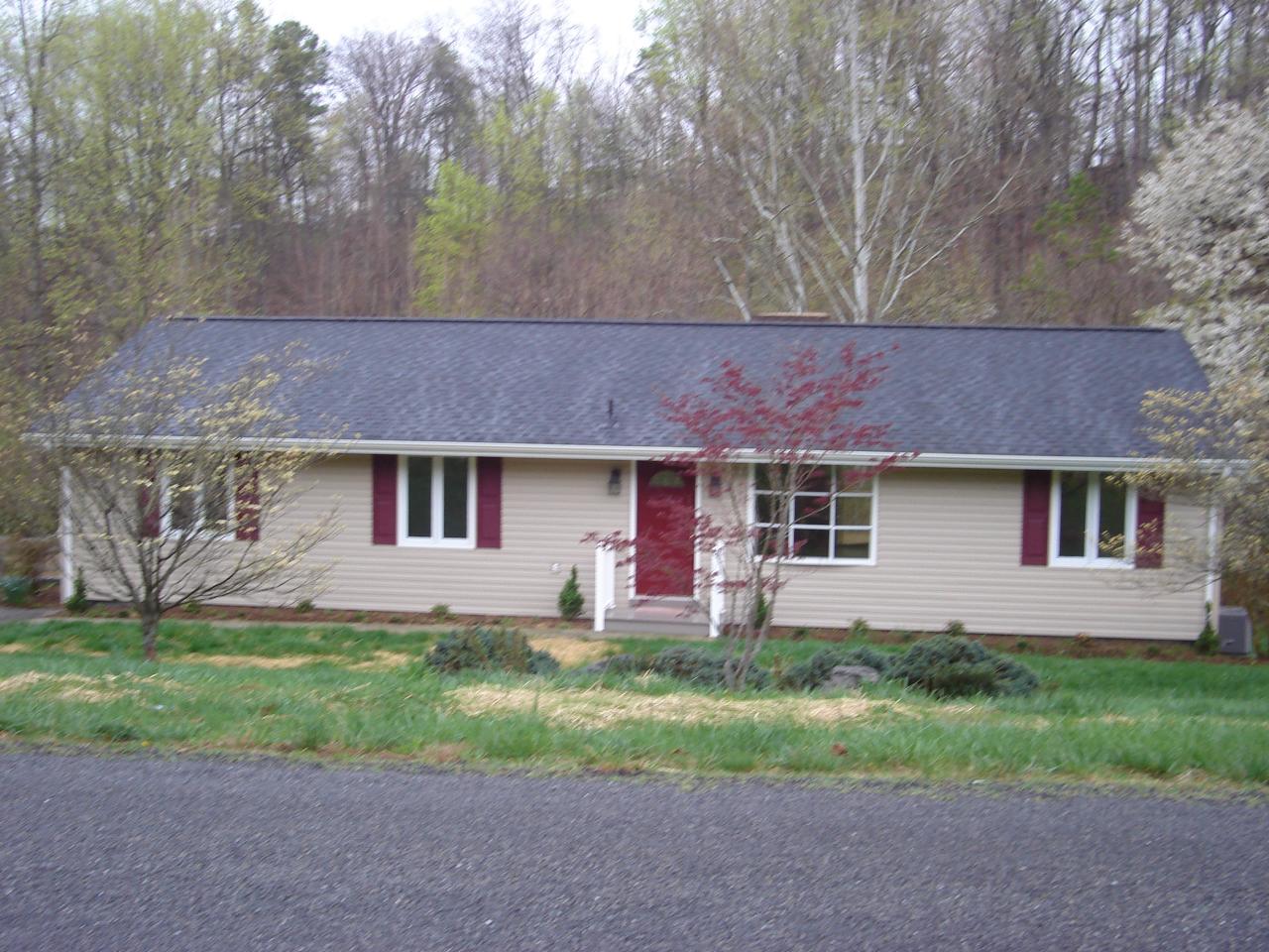 1109 Mountain Pass Road Blue Ridge, VA 24064 - Photo 1 of 18 a front view of house with yard and trees in the background