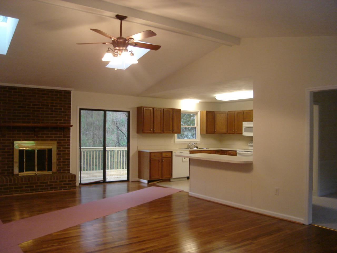 1109 Mountain Pass Road Blue Ridge, VA 24064 - Photo 8 of 18 a view of a kitchen with a sink dishwasher and a fireplace