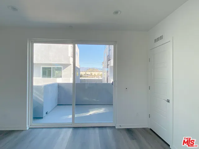 a view of kitchen with wooden floor and window