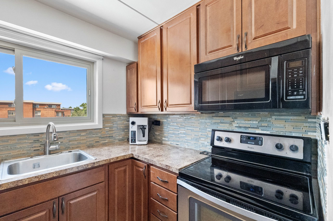 16 East Old Willow Road, Unit 424S Prospect Heights, IL 60070 - Photo 5 of 24 a kitchen with stainless steel appliances granite countertop a sink stove and microwave