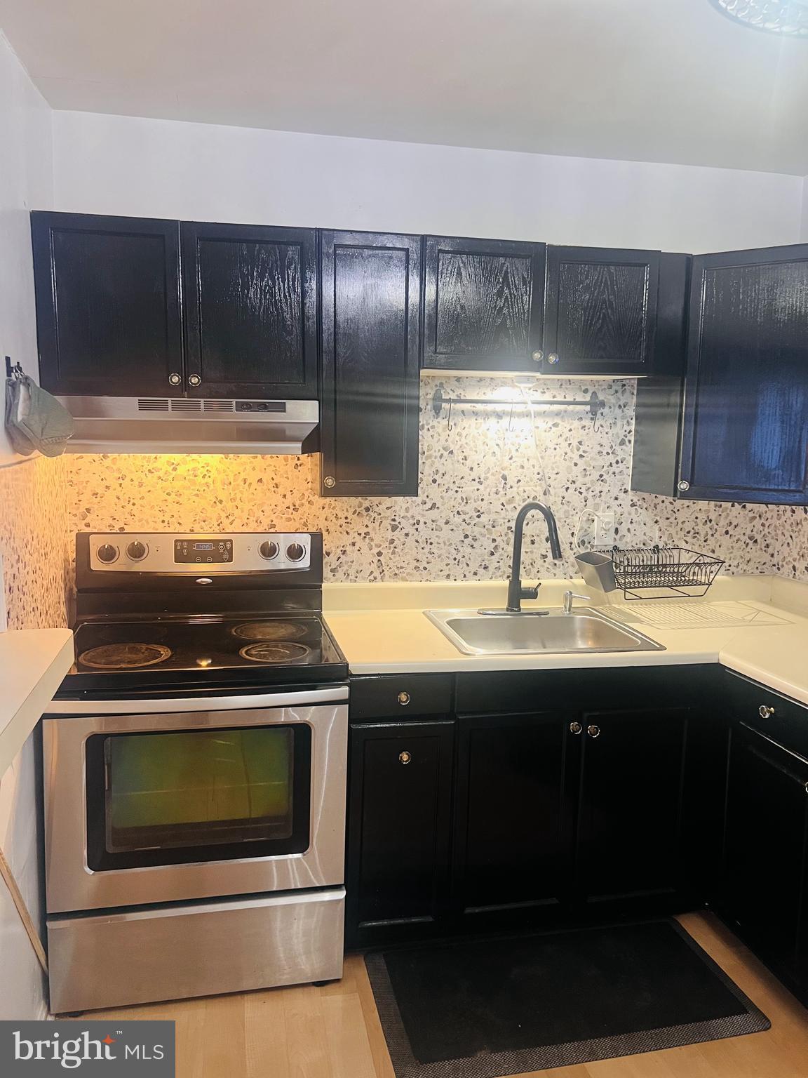 15513 Bealle Hill Road Accokeek, MD 20607 - Photo 9 of 21 a kitchen with granite countertop a stove and a sink