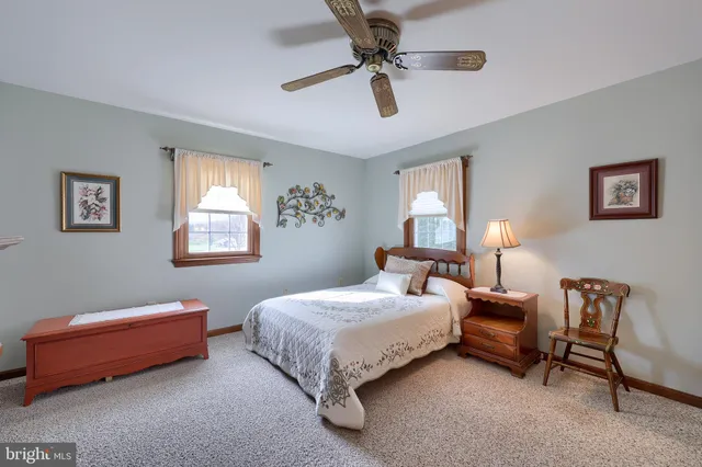 a bedroom with a bed gym equipment and window