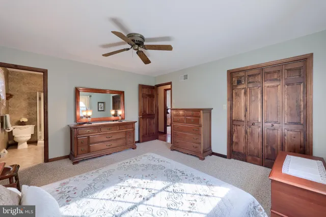 a room with a bed and a dresser