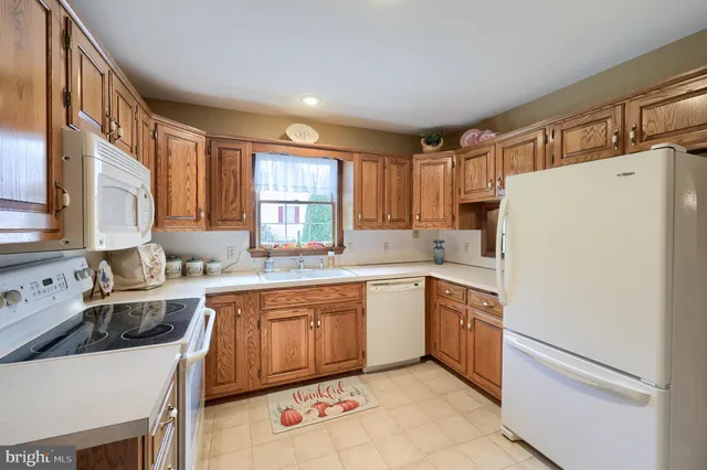 a kitchen with a stove a sink and a refrigerator