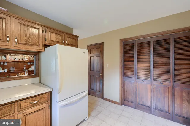 a white refrigerator freezer and a stove sitting inside of a kitchen