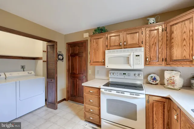 a kitchen with a stove top oven sink and refrigerator