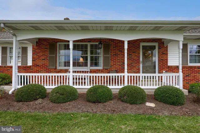 front view of a brick house with a small yard