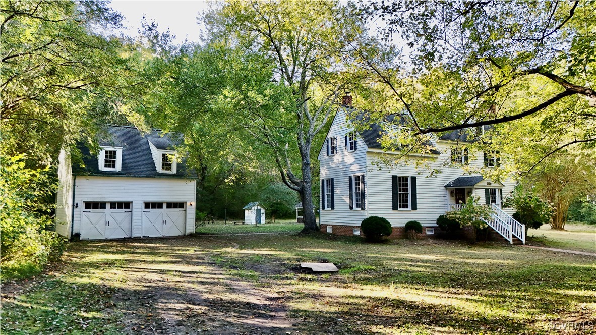 11075 Buckley Hall Road Mathews, VA 23109 - Photo 1 of 38 a view of a house with a yard