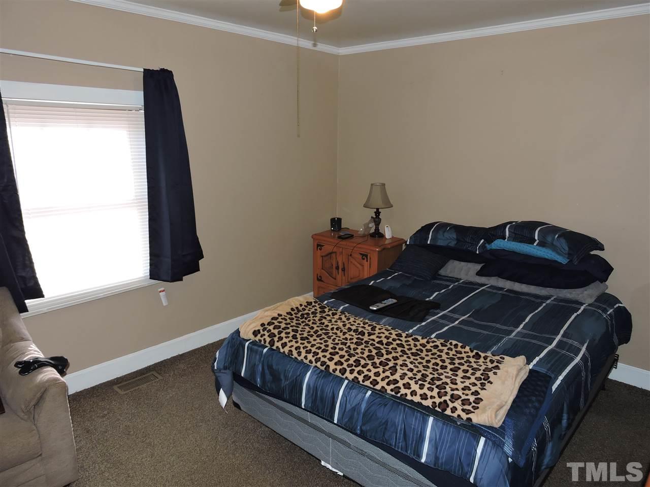 26 Raney Crumpton Road Roxboro, NC 27574 - Photo 4 of 7 a bedroom with a bed and a window