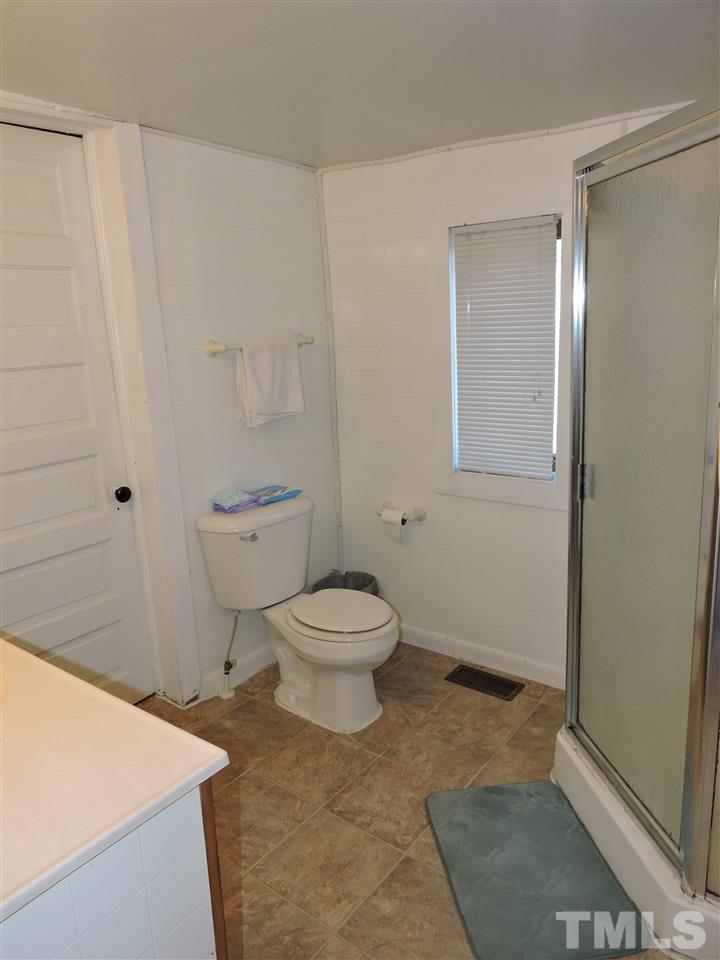 26 Raney Crumpton Road Roxboro, NC 27574 - Photo 5 of 7 a bathroom with a toilet a sink and shower