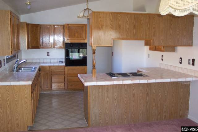 20595 Eaton Road Reno, NV 89521 - Photo 3 of 9 a kitchen with counter top space cabinets and stainless steel appliances