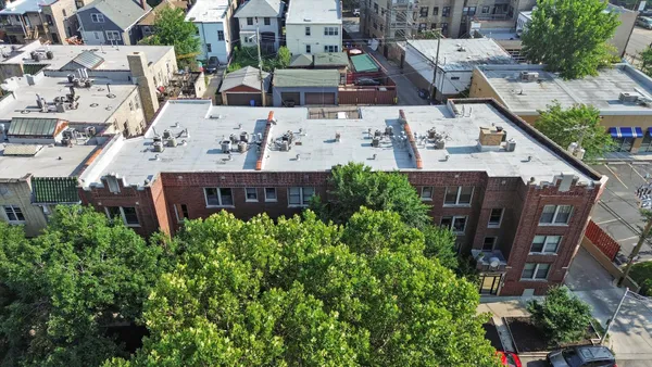 an aerial view of a house with a yard