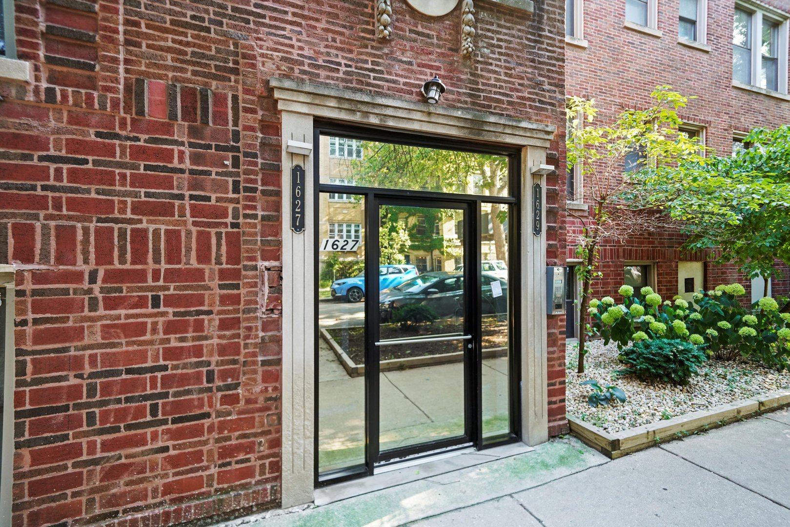 1627 West Columbia Avenue, Unit GW Chicago, IL 60626 - Photo 2 of 28 a front view of a house with a garden