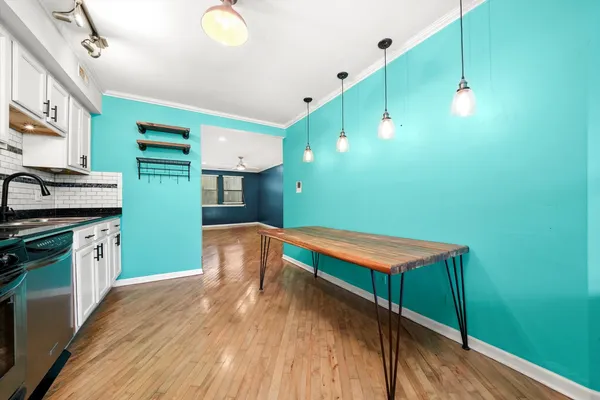 a kitchen with lots of counter top space and wooden floor