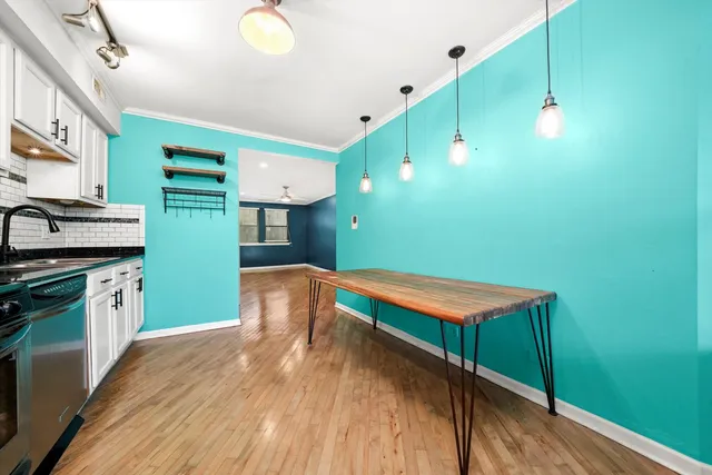 a kitchen with lots of counter top space and wooden floor