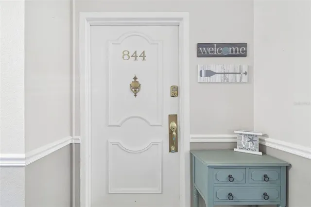 a balcony with wooden floor table and chair