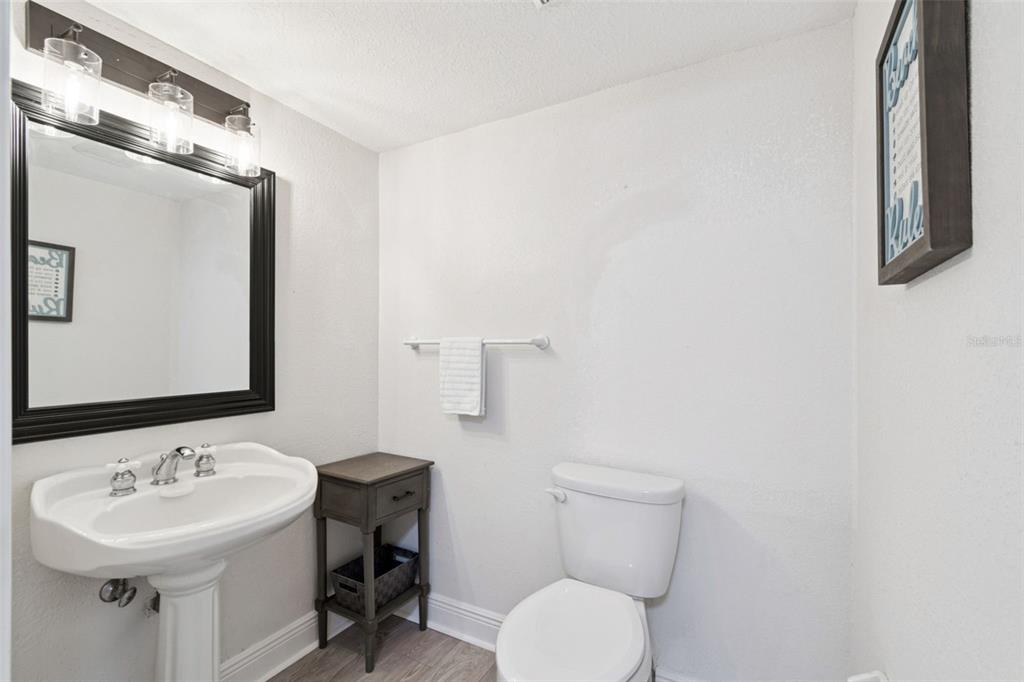 634 Edgewater Drive, Unit 844 Dunedin, FL 34698 - Photo 13 of 68 a bathroom with a toilet sink and mirror