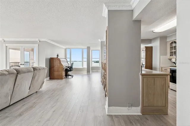 a bed room with a bed and a view of kitchen