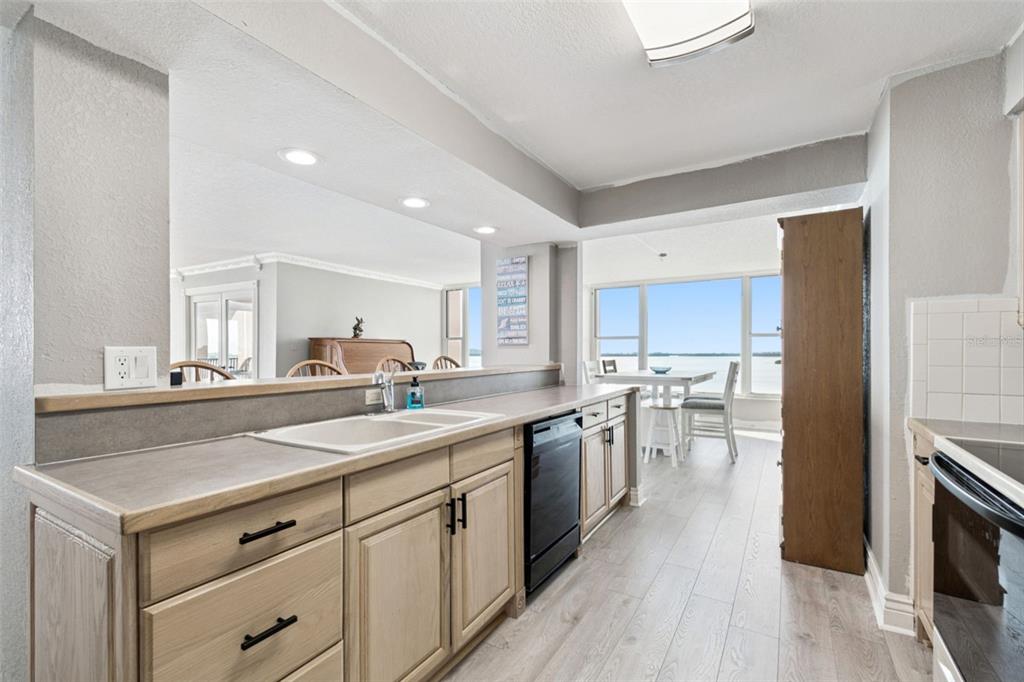 634 Edgewater Drive, Unit 844 Dunedin, FL 34698 - Photo 16 of 68 a kitchen with white cabinets sink and stainless steel appliances