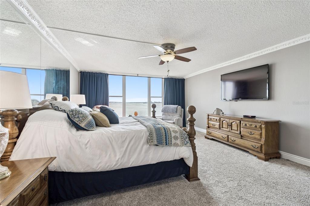 634 Edgewater Drive, Unit 844 Dunedin, FL 34698 - Photo 48 of 68 a bed room with furniture and a flat screen tv